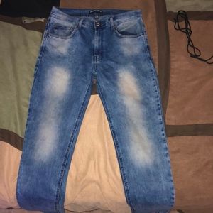 Denim blue jeans with fades of white on pants leg